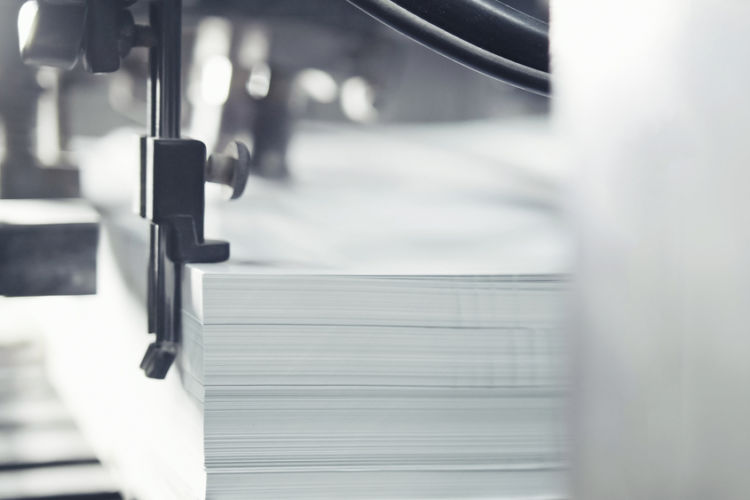printed,sheets,of,paper,are,served,in,the,printing,press.